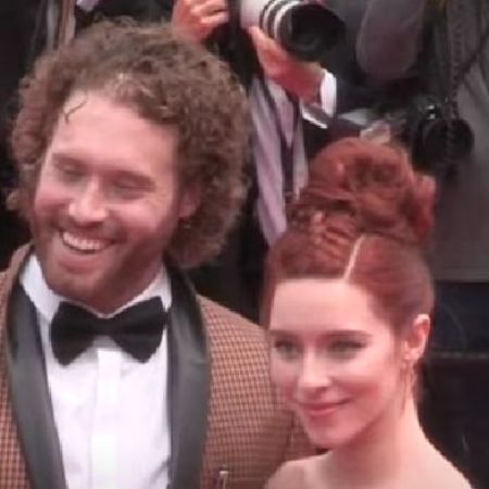 T.J. Miller and Katie Miller are posing for the picture on the red carpet.
